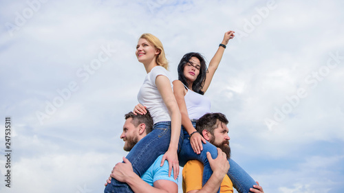 Just let the good times roll. Loving couples enjoy fun together. Loving couples having fun activities outdoor. Playful couples in love smiling on cloudy sky. Happy men piggybacking their girlfriends