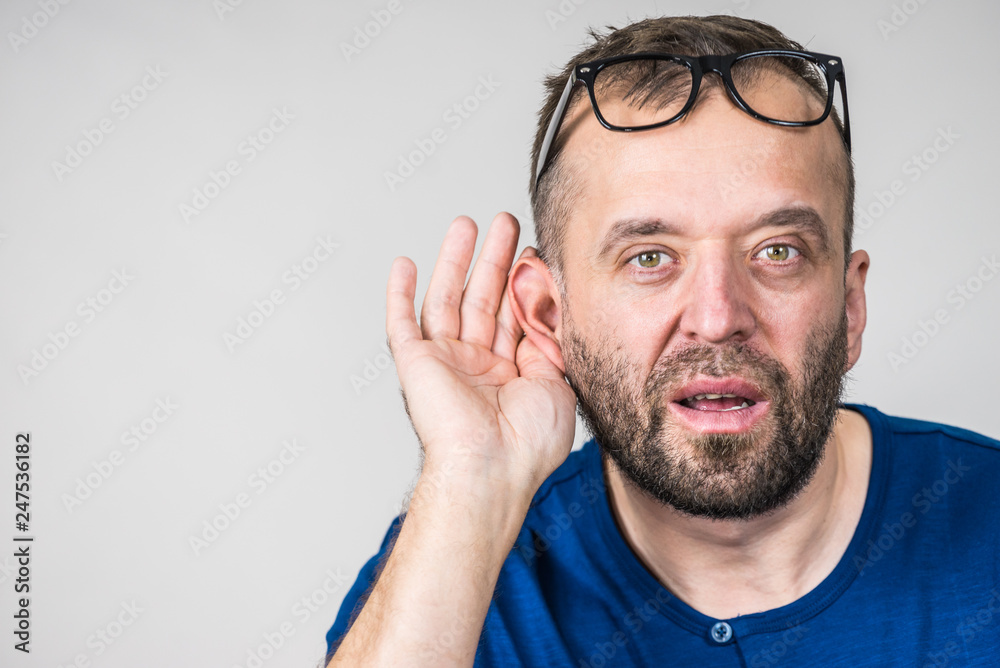 Man eavesdropping with hand close to ear Man eavesdropping with hand close to ear