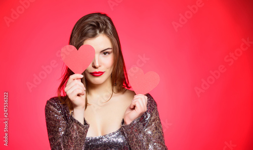 Fall in love. Girl adorable fashion model makeup face hold heart valentines card. Love from first sight. Woman in stylish dress hold symbol love. Romantic mood. Girl in love dating. Obsession concept