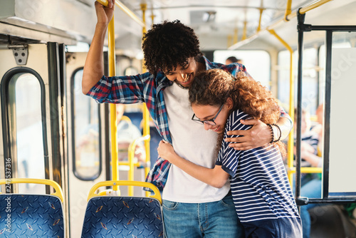 Young multicultural couple hugging in the public transport. © dusanpetkovic1