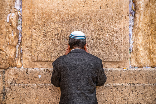 Believing Jew is praying near the wall of crying photo