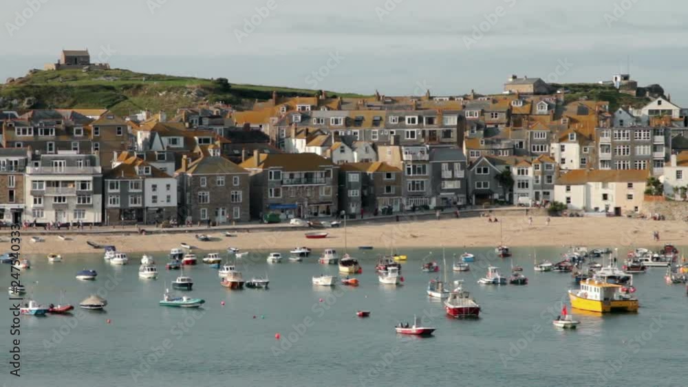 View of St Ives harbour with fishing boats and sandy beach, Cornwall, England View of St Ives harbour with fishing boats and sandy beach, Cornwall, England