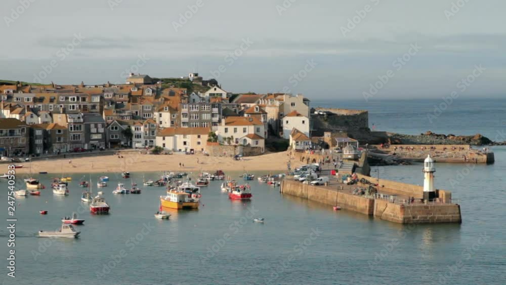 View of St Ives harbour with fishing boats and sandy beach, Cornwall, England View of St Ives harbour with fishing boats and sandy beach, Cornwall, England