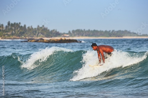 Photography Young man surfing in sea
