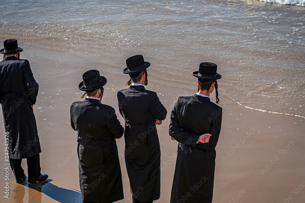 .young Jews on the coast of the Mediterranean Sea in traditional dress