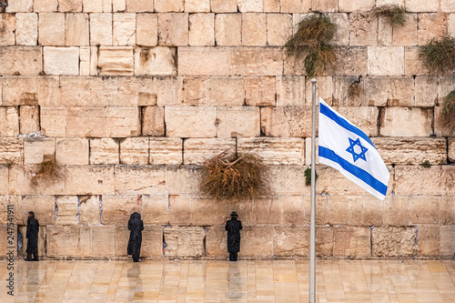 Wallpaper Mural Israeli flag against the western wall  on a cloudy day