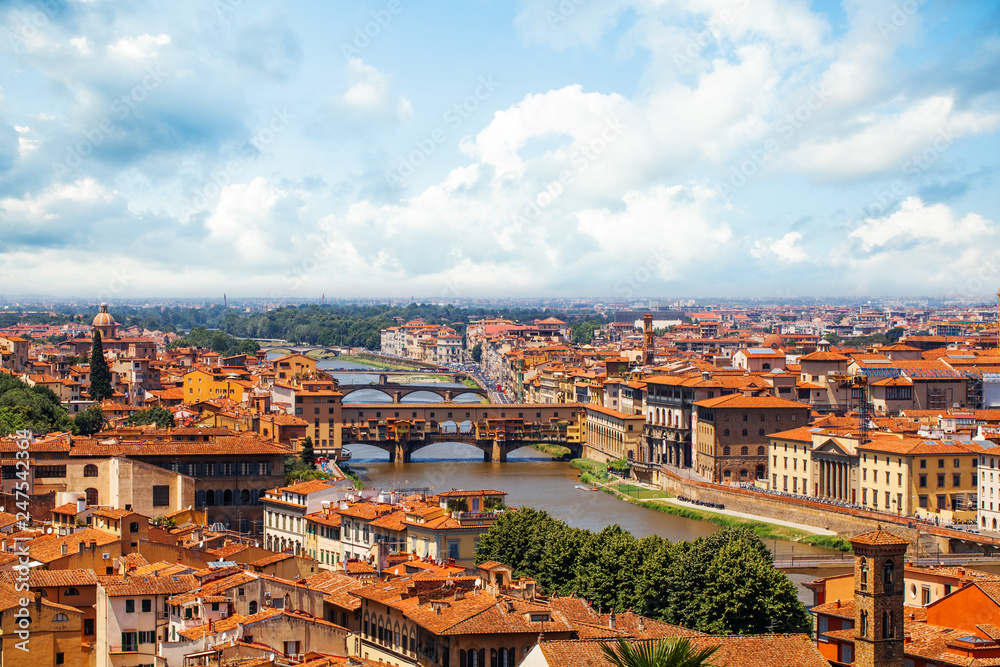 Firenze landmarks. Florence, Italy. Panorama cityscape with red roofs and bridge Ponte Vecchio and the Arno river in Florence