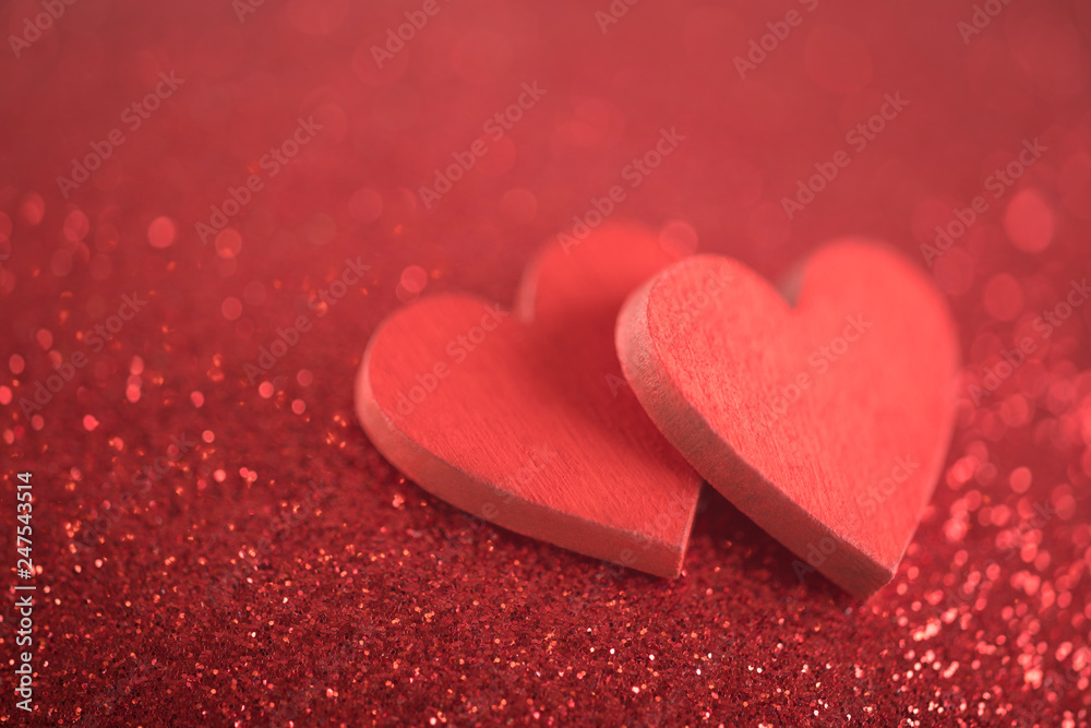 Two red hearts on glitter background in love concept Two red hearts on glitter background in love concept