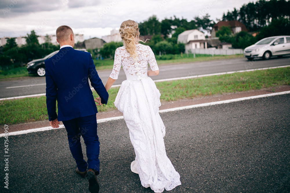 bride and groom walking in the park bride and groom walking in the park