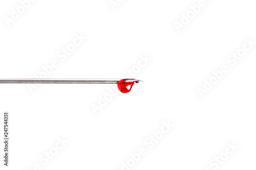 Blood drop on needle of syringe