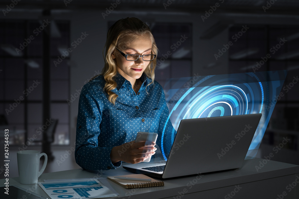 Beautiful blonde in dark office working on laptop and getting net access Beautiful blonde in dark office working on laptop and getting net access