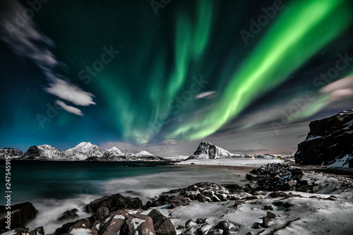 Scenic view of Aurora Borealis over winter landscape