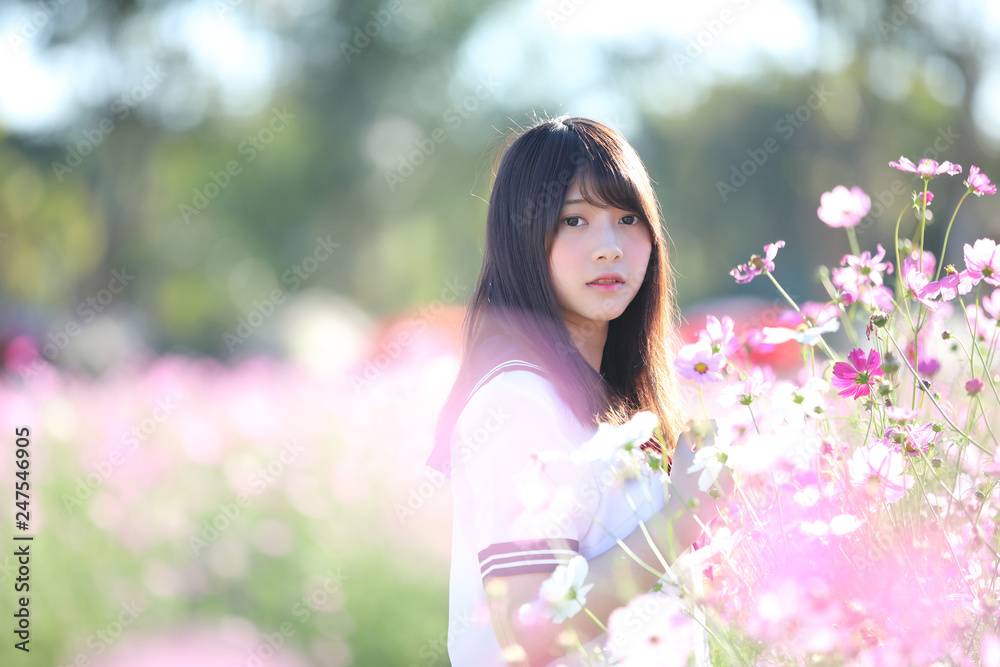 Portrait of Japanese school girl uniform with cosmos flower Portrait of Japanese school girl uniform with cosmos flower