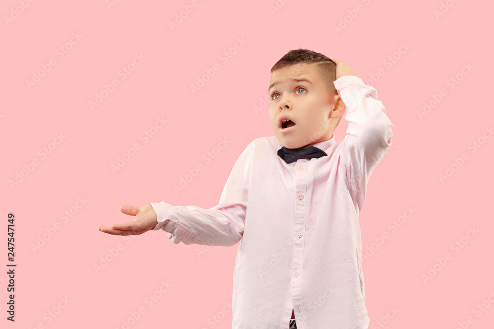Why is that. Beautiful male half-length portrait isolated on trendy pink studio backgroud. Young emotional surprised, frustrated and bewildered teen boy. Human emotions, facial expression concept. Why is that. Beautiful male half-length portrait isolated on trendy pink studio backgroud. Young emotional surprised, frustrated and bewildered teen boy. Human emotions, facial expression concept.