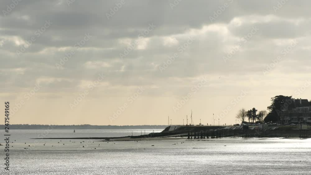 Landscape from the city of Saint-Nazaire, in western france, in the Loire estuary, in the loire atlantique region. Cloudy sky and ray of light. Filmed during the winter. 