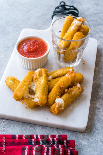 Breaded Fried Mozzarella Cheese Sticks with Ketchup Dipping Sauce.