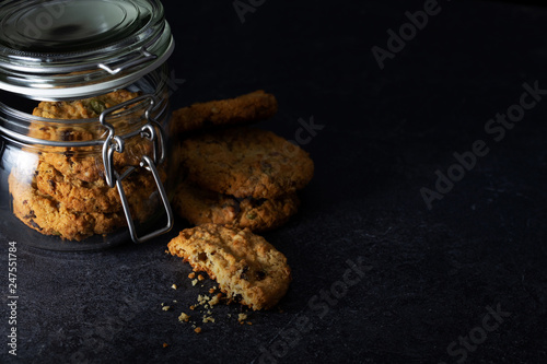 Cookies in glass jar on dark background photo