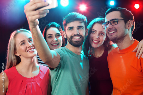 Group of happy friends taking selfie