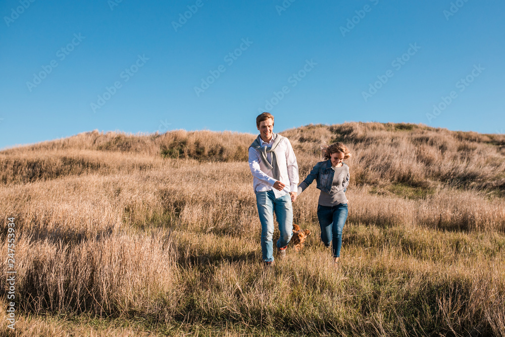 Happy young couple playing and laughing outdoors.