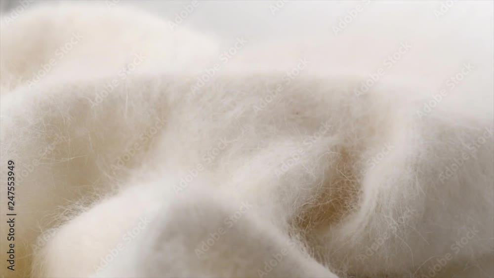 Soft wool background. Alpaca wool mohair clothes texture closeup. Natural cashmere fluffy merino wool. Woolen fabric. Rotated. 4K UHD video footage. 3840X2160 Soft wool background. Alpaca wool mohair clothes texture closeup. Natural cashmere fluffy merino wool. Woolen fabric. Rotated. 4K UHD video footage. 3840X2160