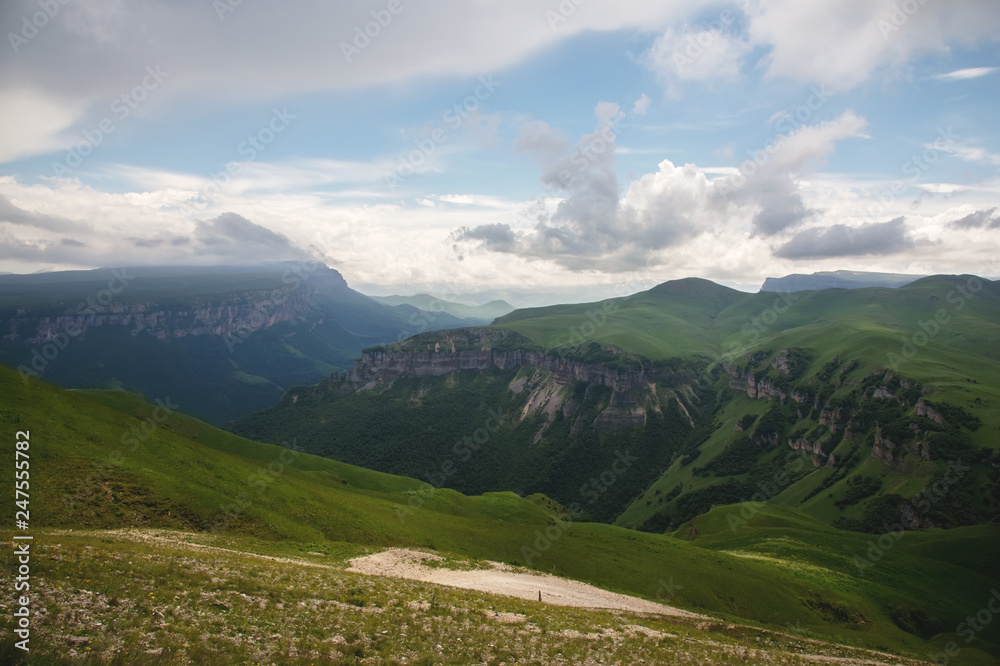 Dramatic landscape of a green valley at the foot of the Inal Plateau in the North Caucasus