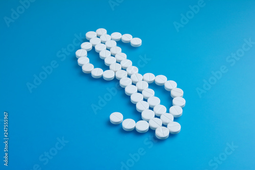 Business on drugs, isolated. Healthcare concept. Tablets on blue background. Flat lay.