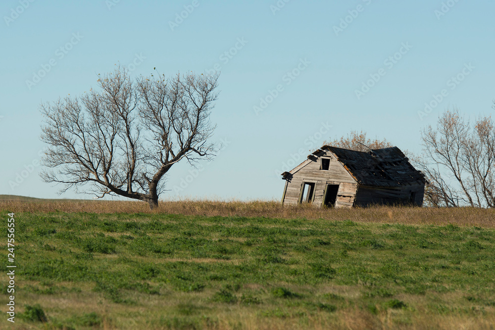An old farmhouse on the prairie in North Dakota An old farmhouse on the prairie in North Dakota