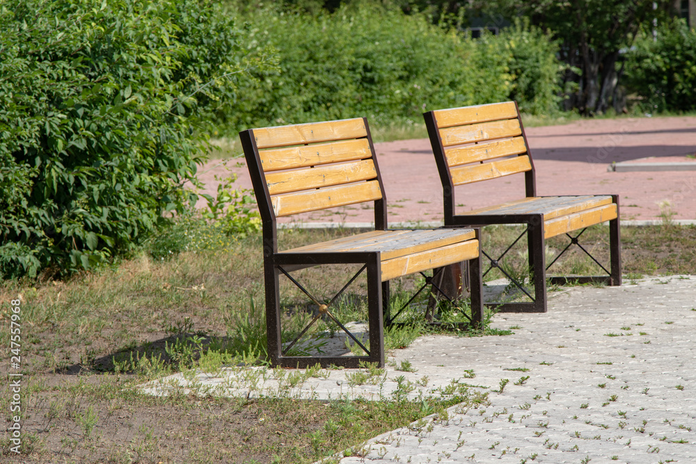 wooden benches in summer park wooden benches in summer park