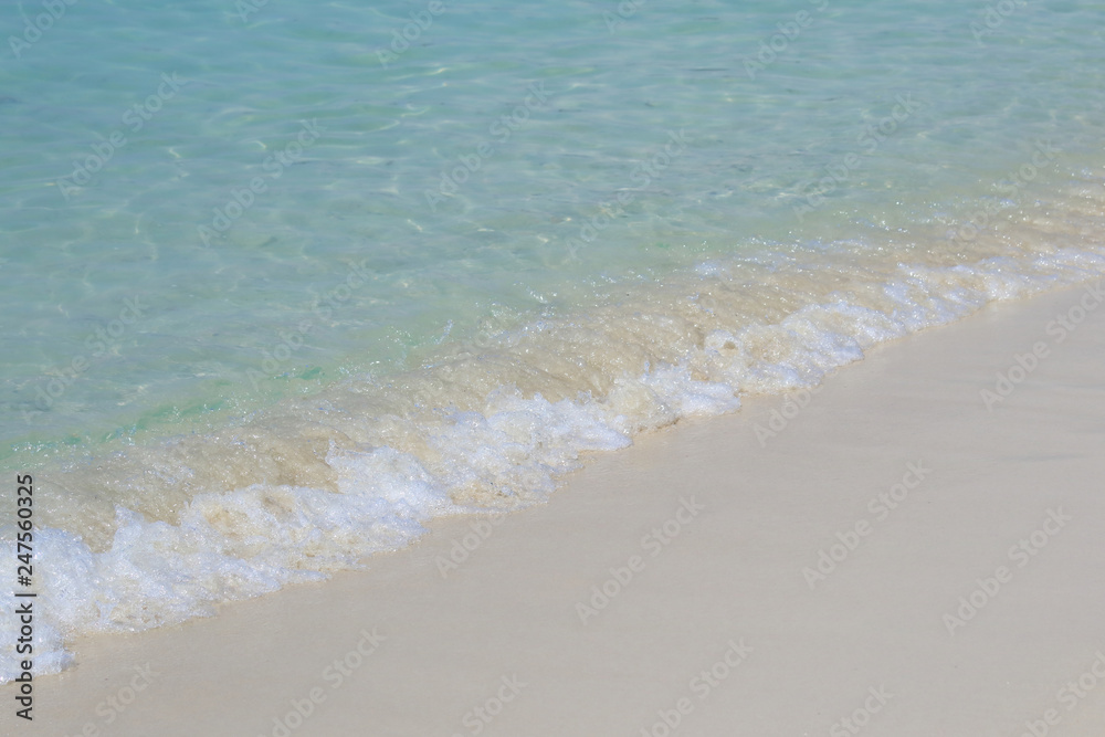 Beautiful sandy beach and soft blue ocean wave