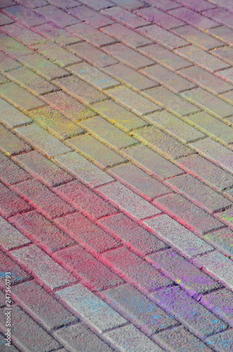 Multi colored paving slabs, powder coated with dry colors at the Holi festival photo