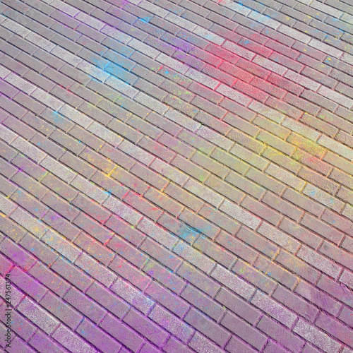 Multi colored paving slabs, powder coated with dry colors at the Holi festival photo