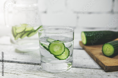 glass with cucumber water on the table