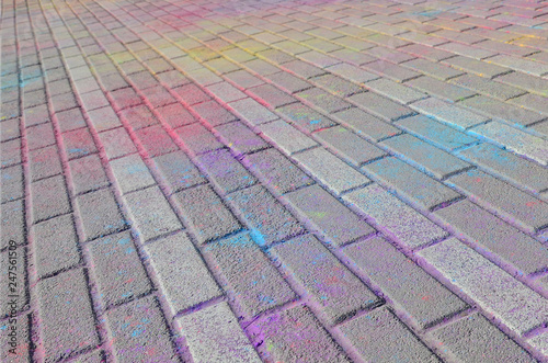 Multi colored paving slabs, powder coated with dry colors at the Holi festival photo