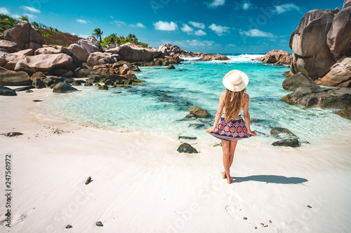 A young girl standing in shallow water on La Digue island, Seychelles