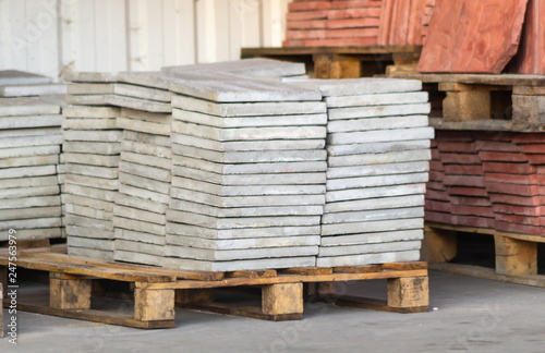 Paving slabs factory. Tiles piled in pallets.