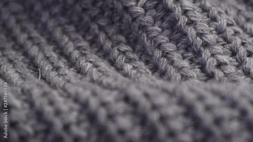 Wool background. Grey wool clothes texture closeup, dolly shot. Knitted soft gray merino wool macro shot. Natural woolen fabric. 4K UHD video footage. 3840X2160 Wool background. Grey wool clothes texture closeup, dolly shot. Knitted soft gray merino wool macro shot. Natural woolen fabric. 4K UHD video footage. 3840X2160