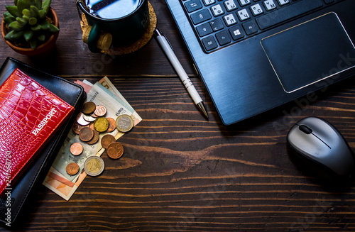 calculator and pen on wooden table