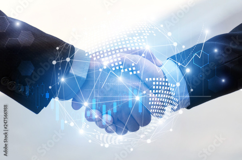 business man handshake with effect global world map network link connection and graph chart of stock market graphic diagram, digital technology, internet communication, teamwork, partnership concept photo