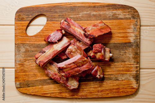Smoked pork ribs juicy and meaty on a wooden cutting board