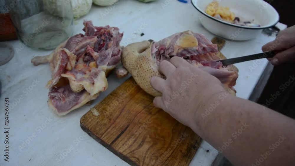 Cutting up carcass goose close up.