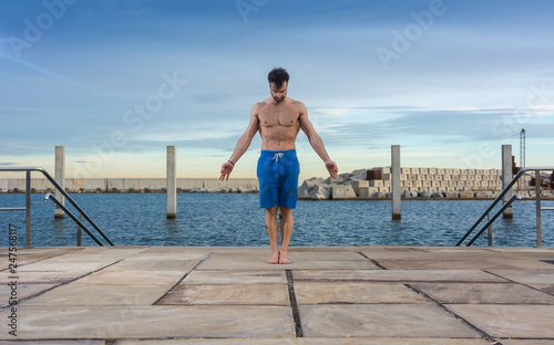 Man performing advanced yoga exercises and stretching.