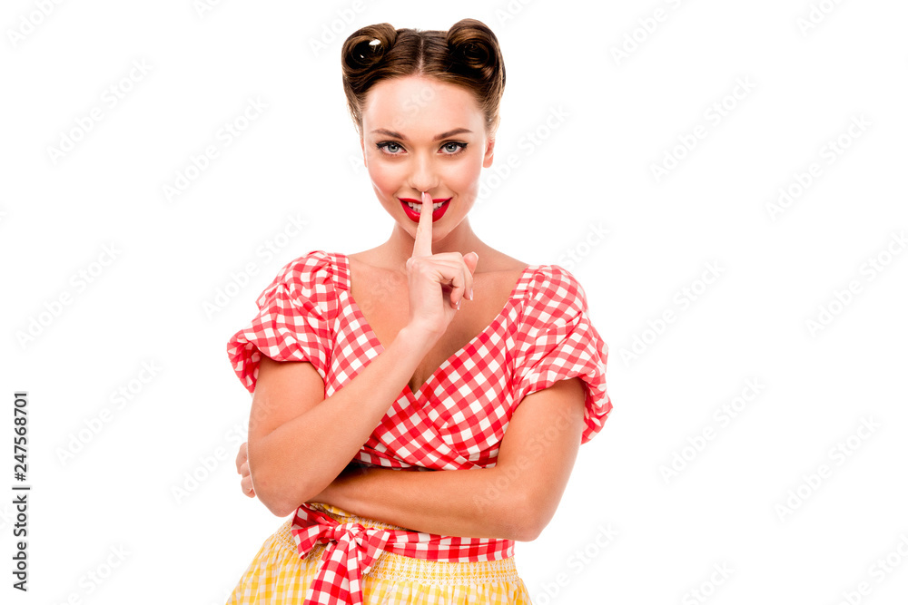 Young pin up girl showing silence sign isolated on white Young pin up girl showing silence sign isolated on white