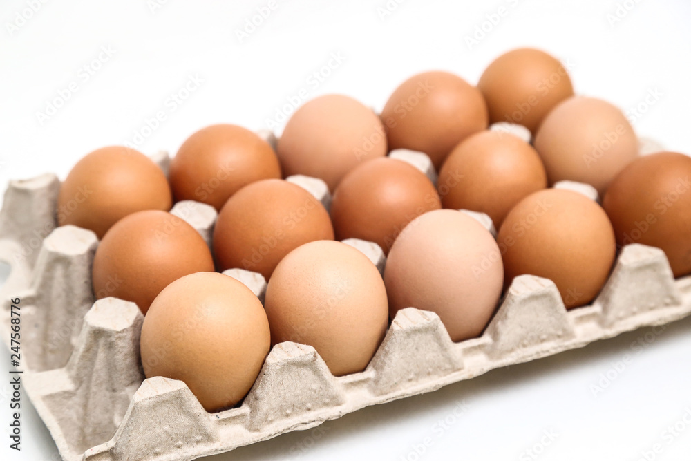 Fresh chicken eggs in paper tray isolated on white background Fresh chicken eggs in paper tray isolated on white background