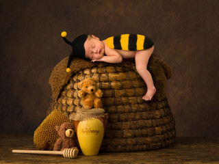Cute baby sleeping on beehive