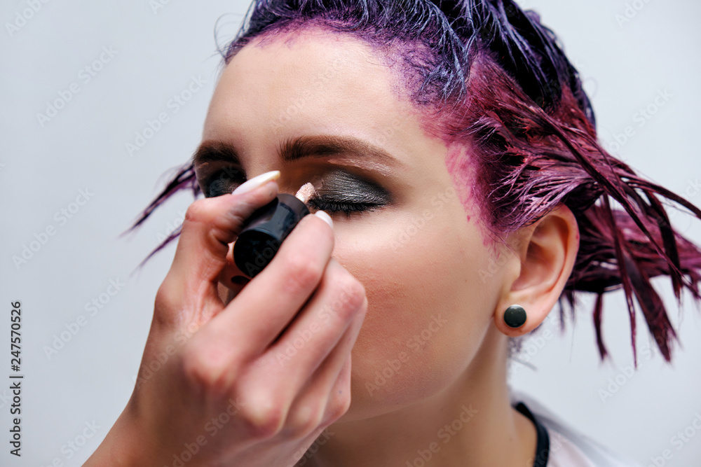 Beautiful girl with violet hair on white background master in make-up. Beautiful girl with violet hair on white background master in make-up.