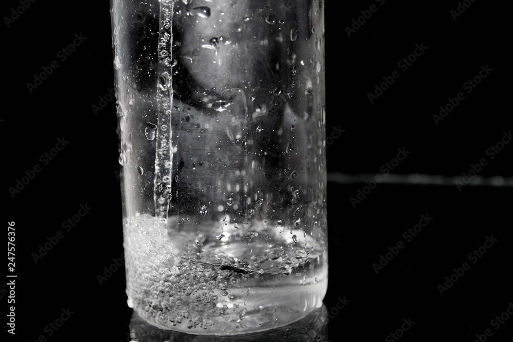 Splash of water on black, Stylish water splash. Isolated on black background, bubbles in the glass, the fog on the glass, water poured into the vessel Splash of water on black, Stylish water splash. Isolated on black background, bubbles in the glass, the fog on the glass, water poured into the vessel