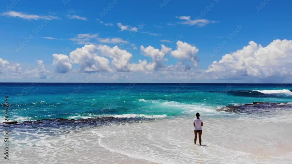 The girl on the ocean. Aerial video from the drone. Seychelles. Beach Anse Police. For advertising. The girl on the ocean. Aerial video from the drone. Seychelles. Beach Anse Police. For advertising.
