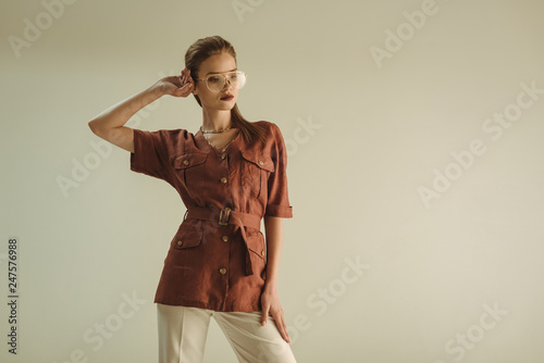 attractive fashionable woman in vintage clothing posing isolated on beige
