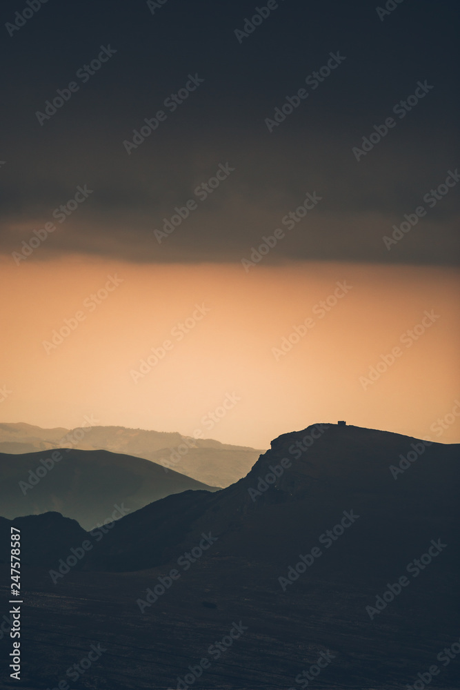 Breathtaking sunset views from Bucegi National Park in Romania.Mountain peak silhouette