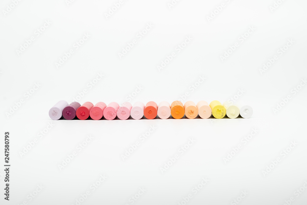 Pastel crayons lined up on a white background Pastel crayons lined up on a white background